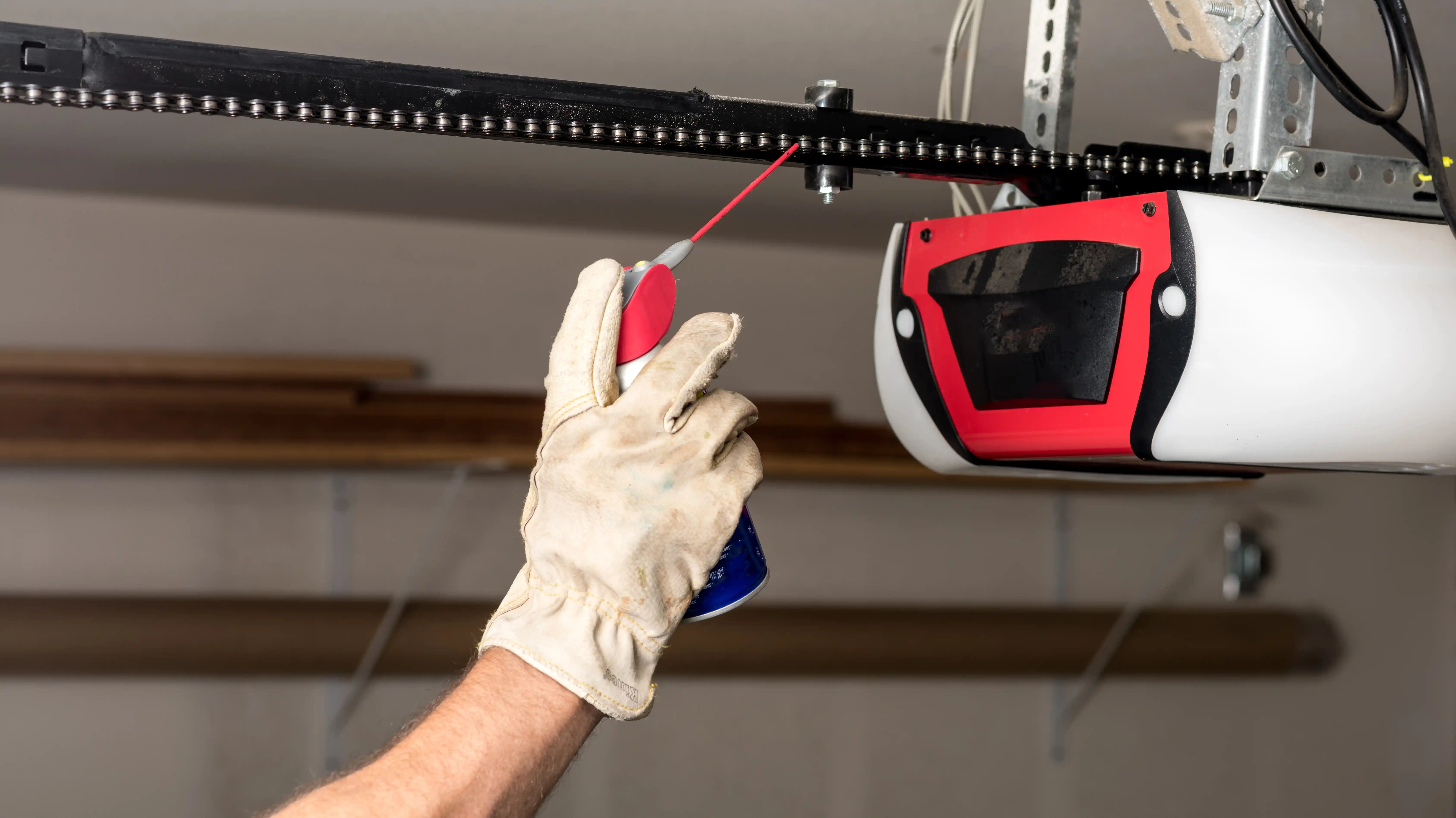Technician repairing a damaged garage door in Salt Lake City